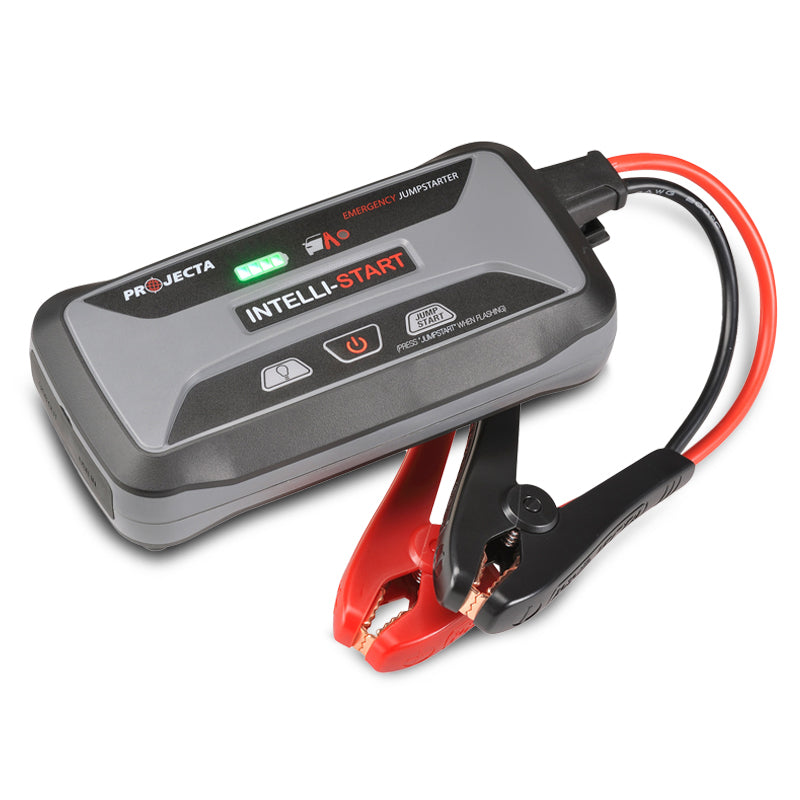 A compact gray Projecta IS920 jump starter with red and black jump cables and an LED light built into the front.
