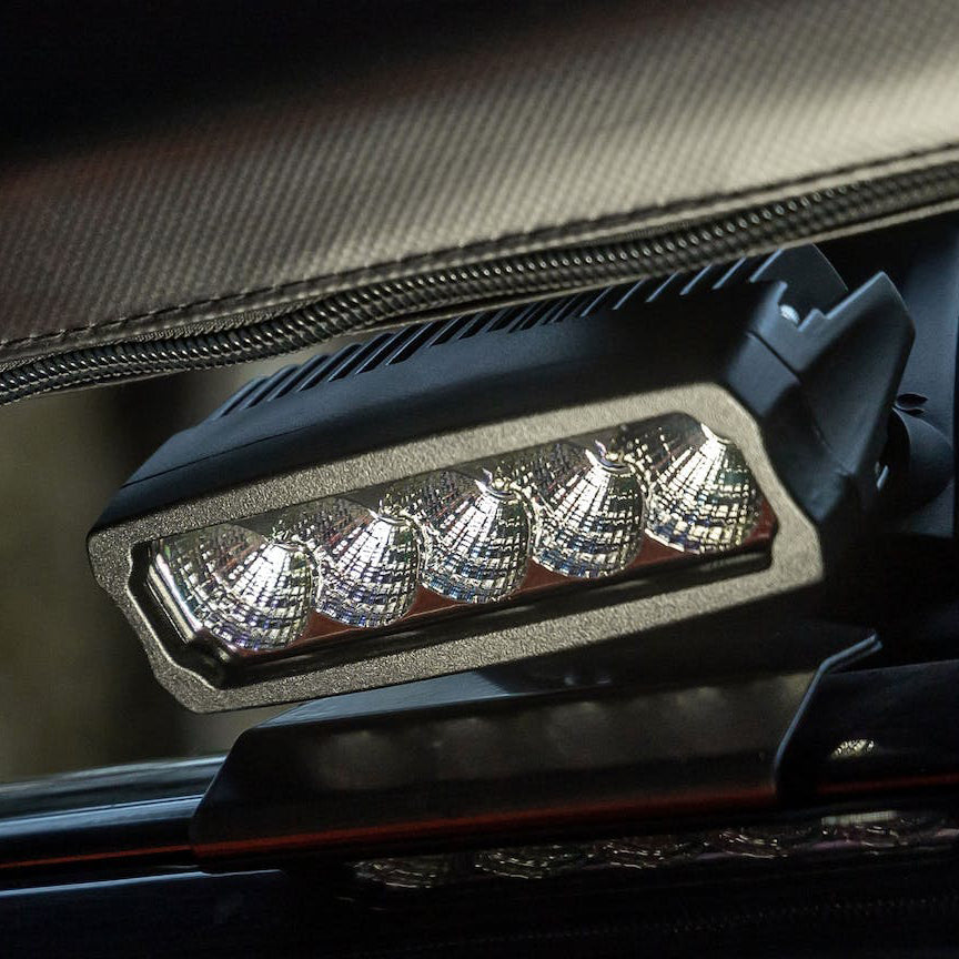 Work light fitted under a bar on a vehicle, its five lenses facing forward