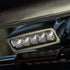 Work light fitted under a bar on a vehicle, its five lenses facing forward