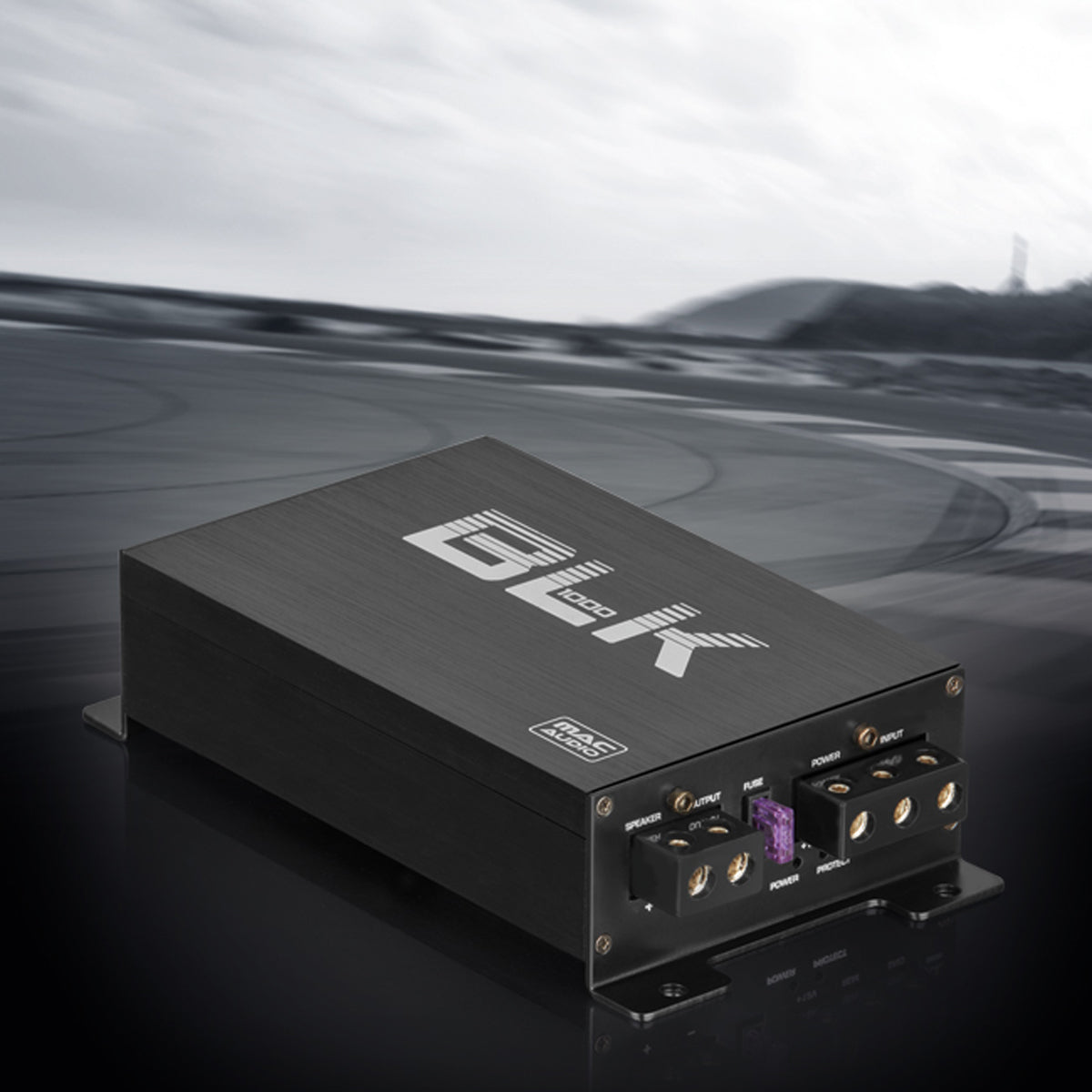 Black brushed amplifier with BLK 1000 graphics on a grey racetrack backdrop