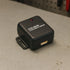 Black impact sensor labeled 'Model MES80' on a concrete surface