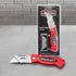 Utility knife and retail pack on a grey workshop background