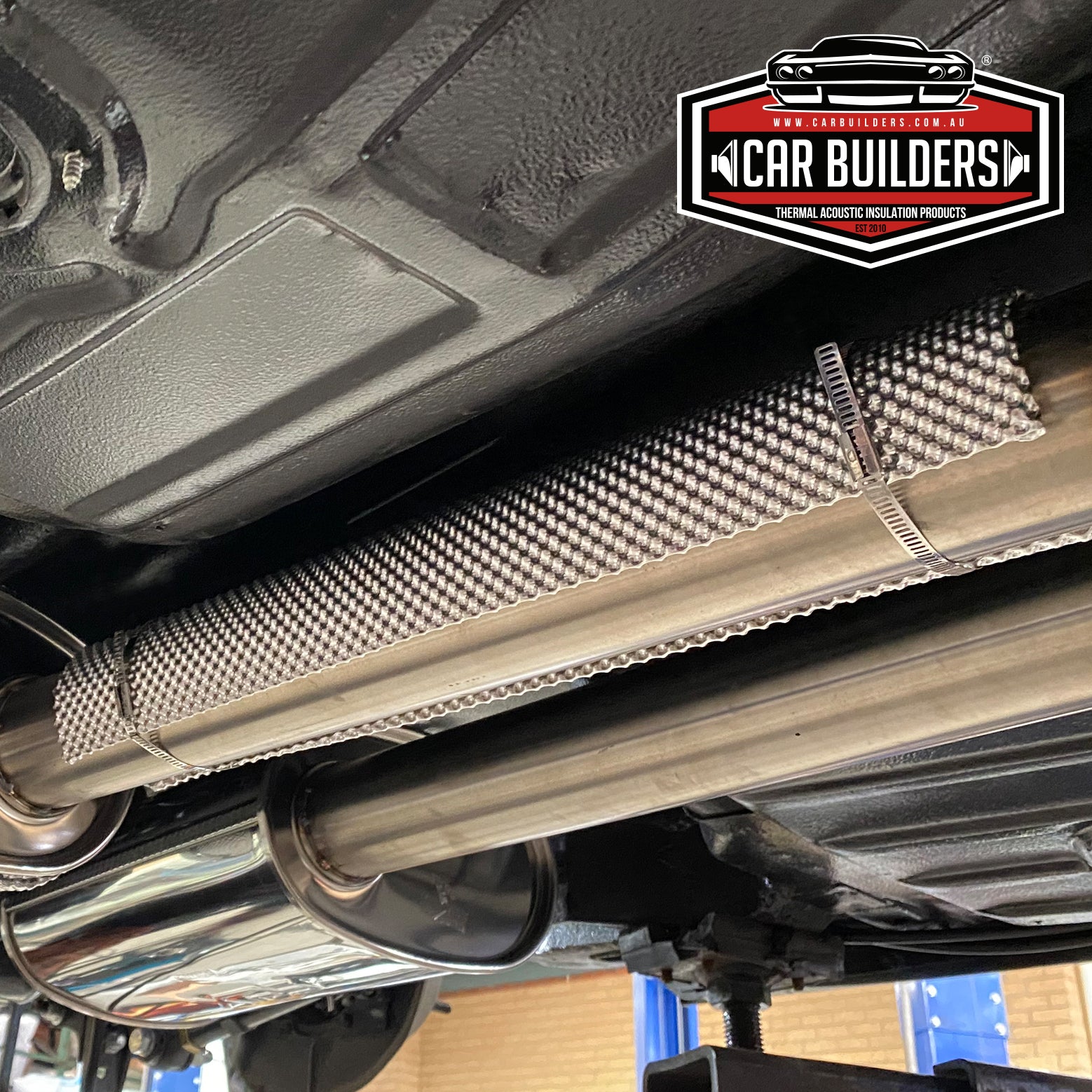 Click Ties holding an embossed heat shield on an exhaust pipe under a vehicle