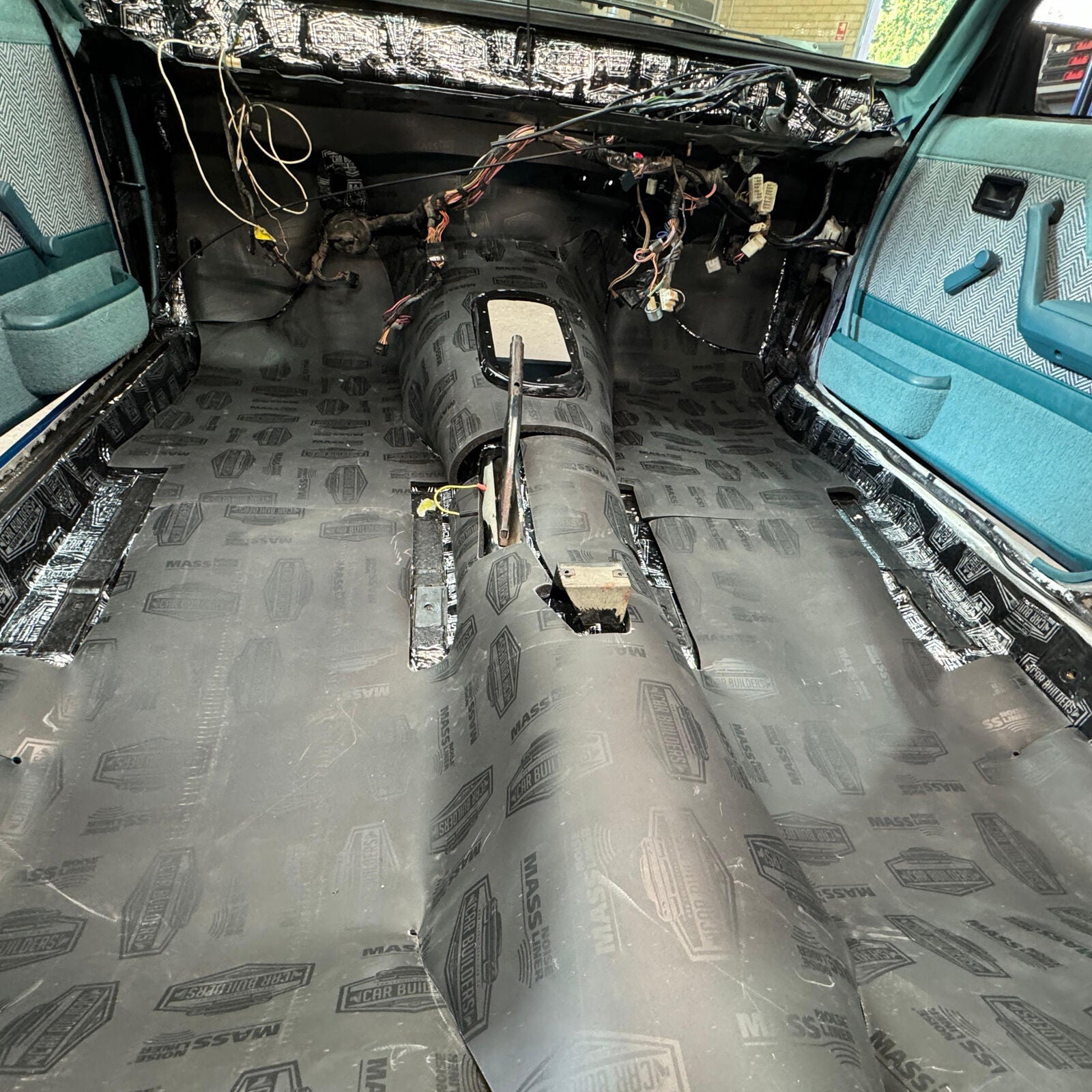 Pre cut black liner across a Commodore floor