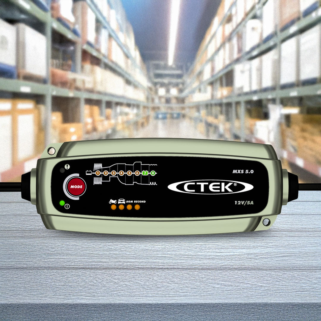 Green CTEK MXS 5.0 12V 5A smart battery charger showing digital screen and leads