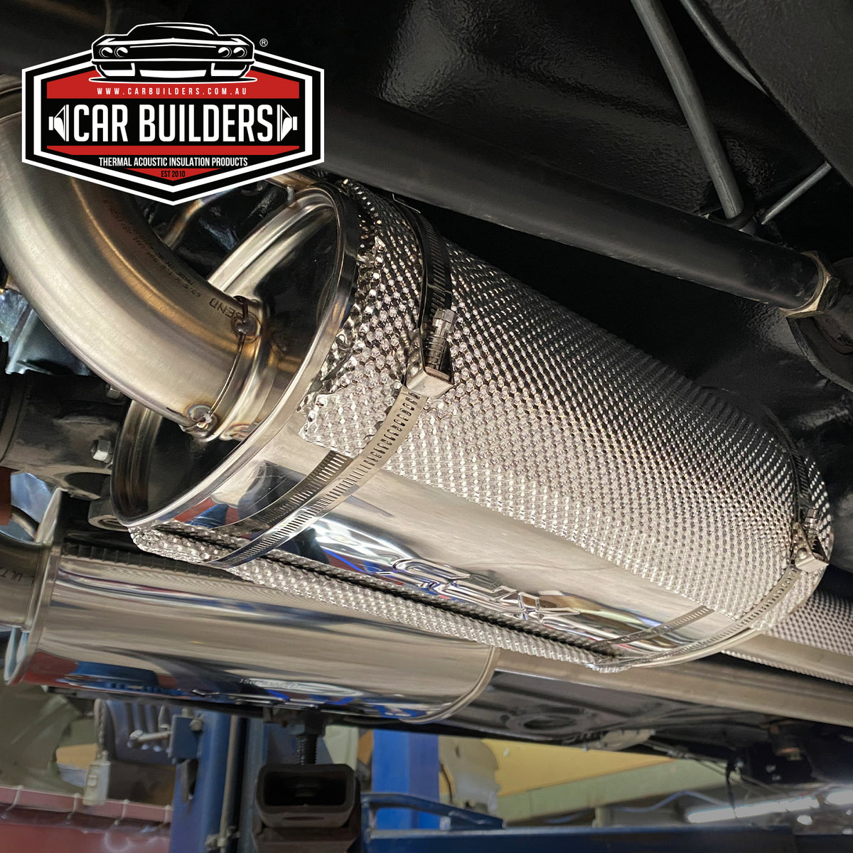 Direct To Heat Muffler Shield clamped onto an exhaust muffler under a vehicle