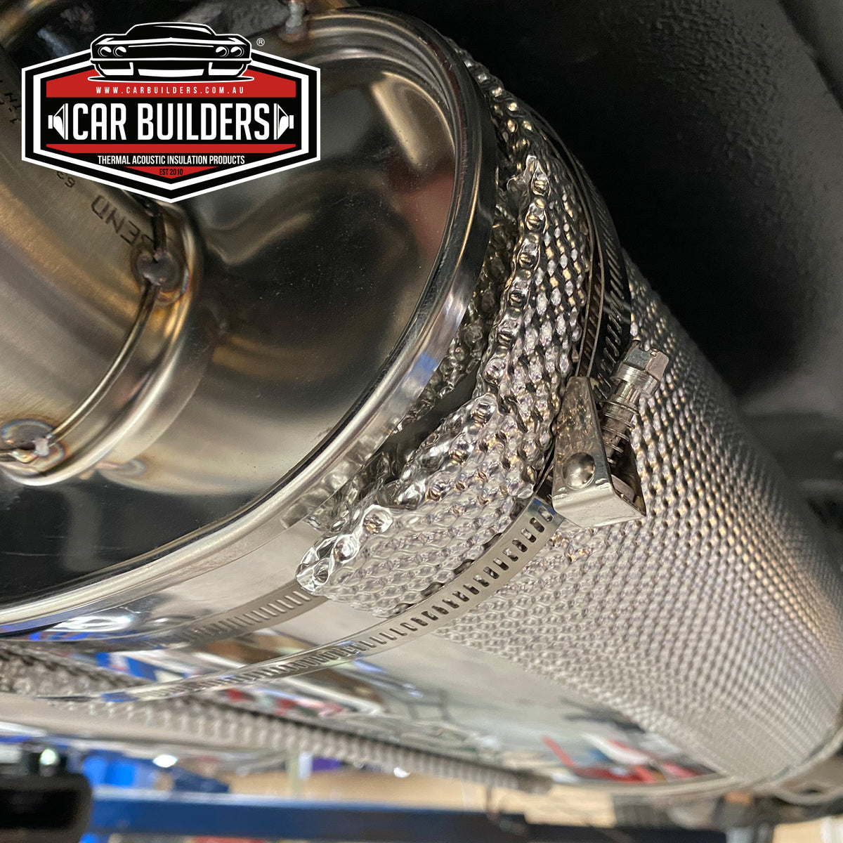 Close view of the dimpled aluminium muffler shield and hose clamps fitted to a muffler