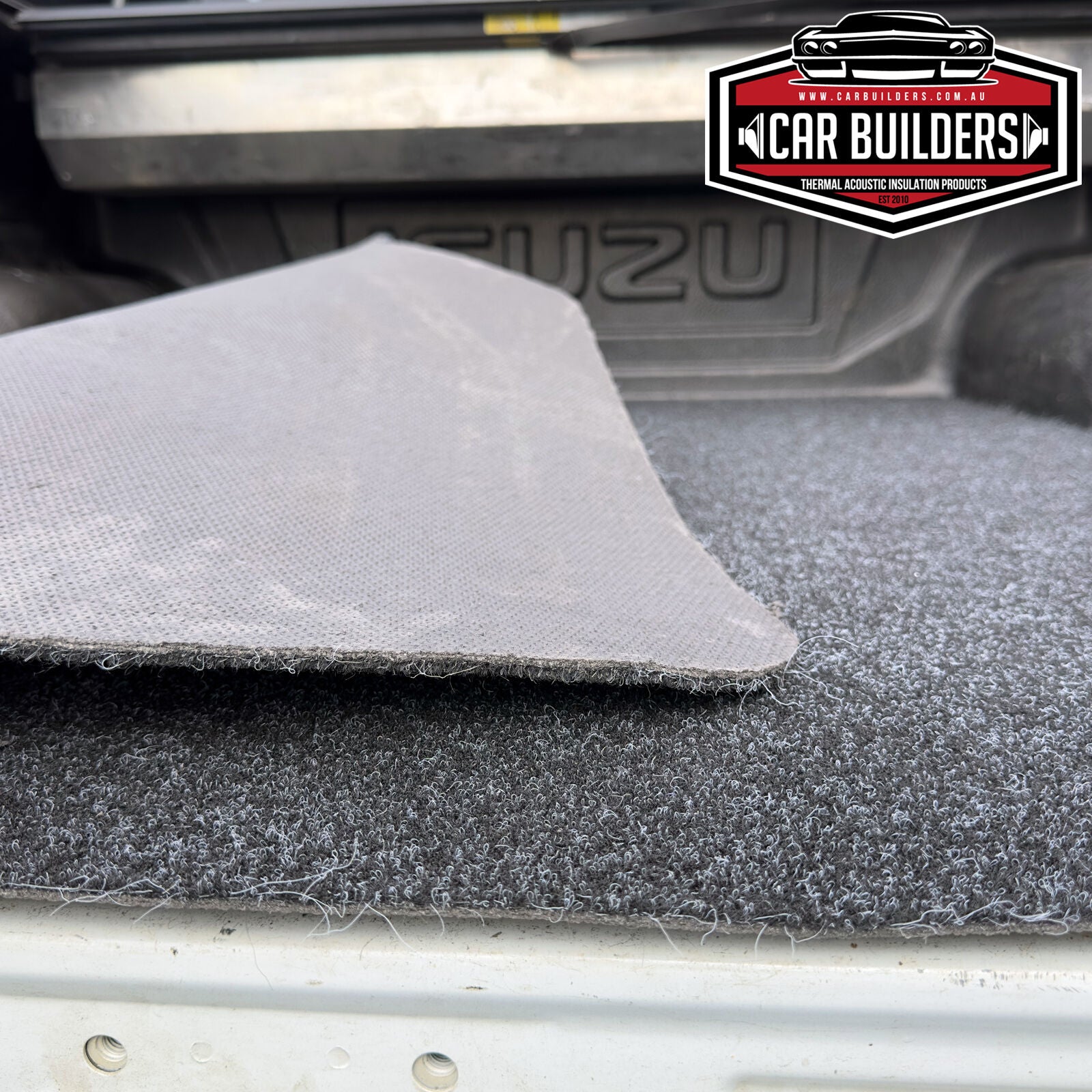 Corner of the D-MAX cargo mat lifted to show the backing