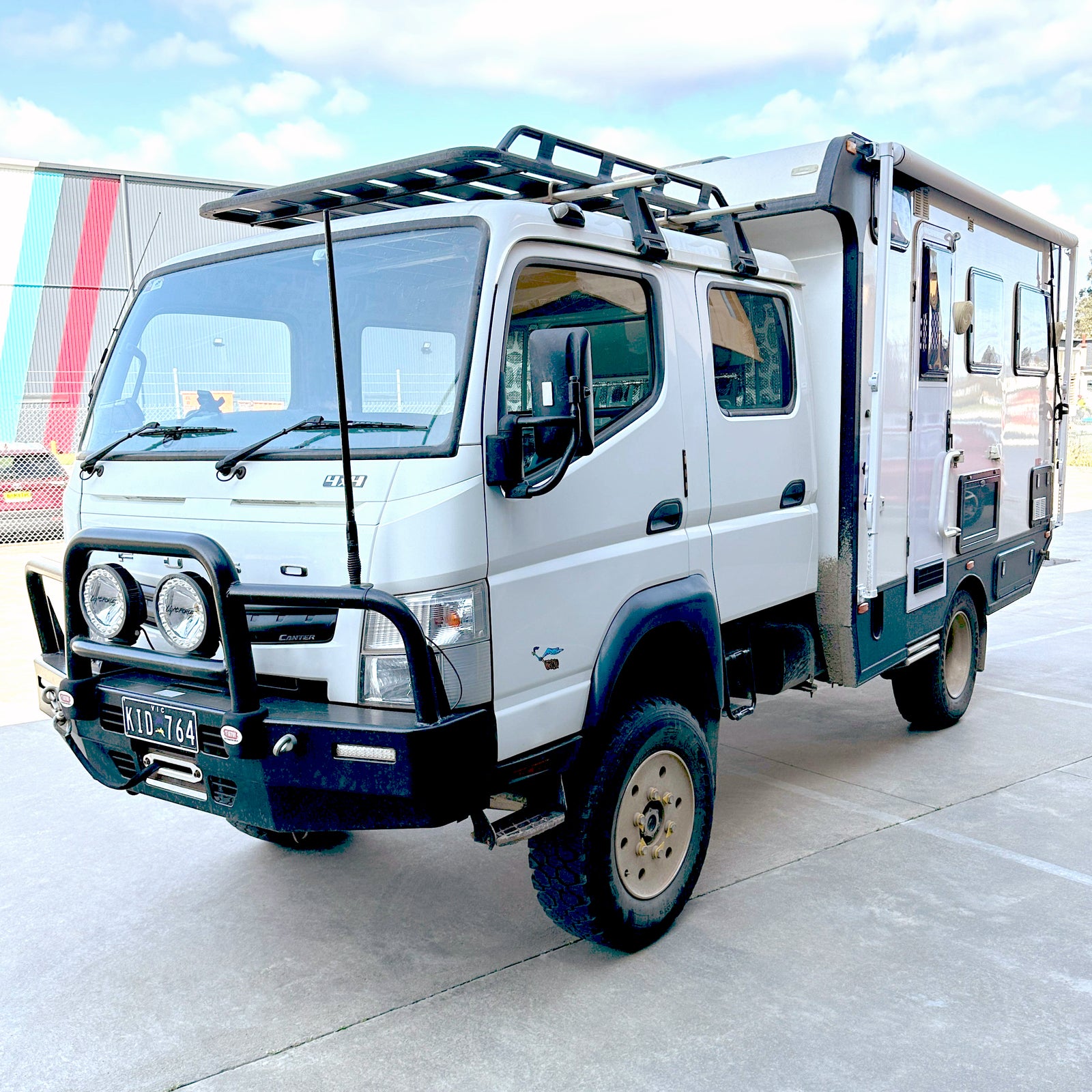 White Fuso Canter crew cab with a camper body