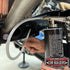 Underbody spray gun with hose extension fitted to a bottle under a vehicle