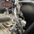 Wiring loom wrapped in heat reflective foil tape in an engine bay