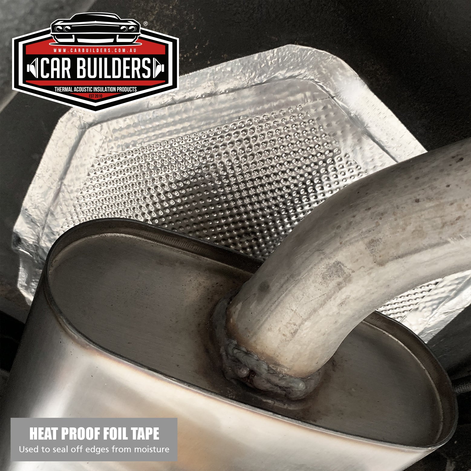 Heat reflective foil tape sealing a heat shield beside an exhaust muffler
