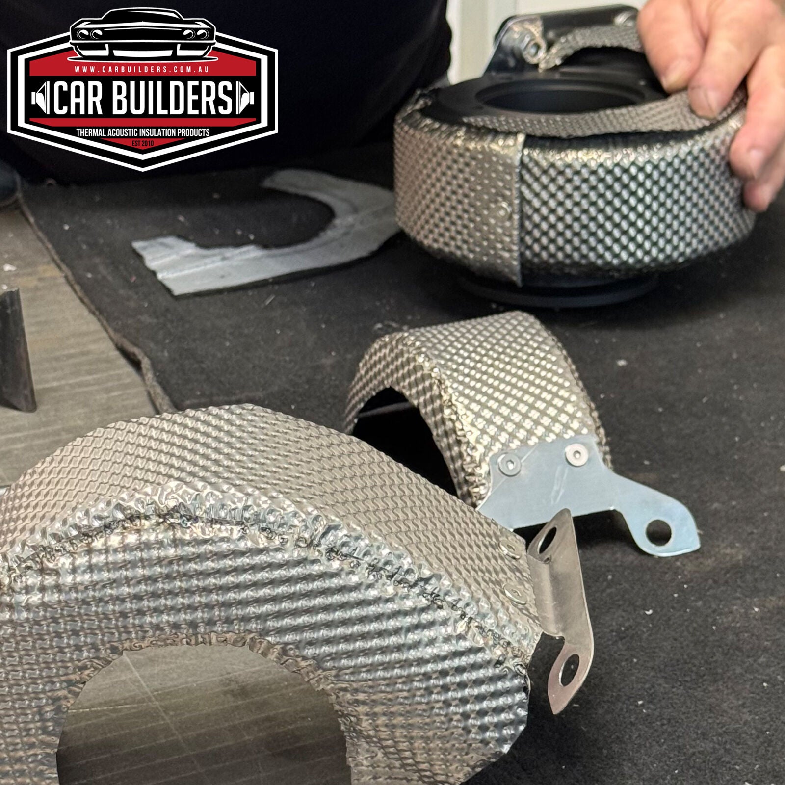 Hand fitting a formed Inconel heat shield over a turbo housing