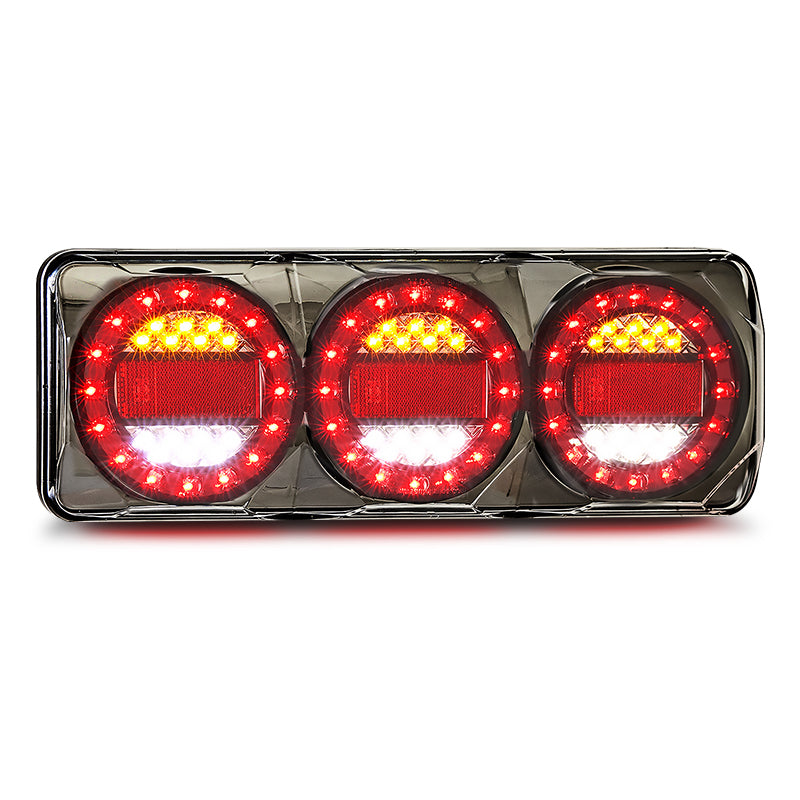 LED Autolamps MAXILAMPC3XRWB 12/24V Maxilamp Stop/Tail/Indicator/Reverse/Reflector Combo Lamp featuring a black chrome housing with red and white lights visible.