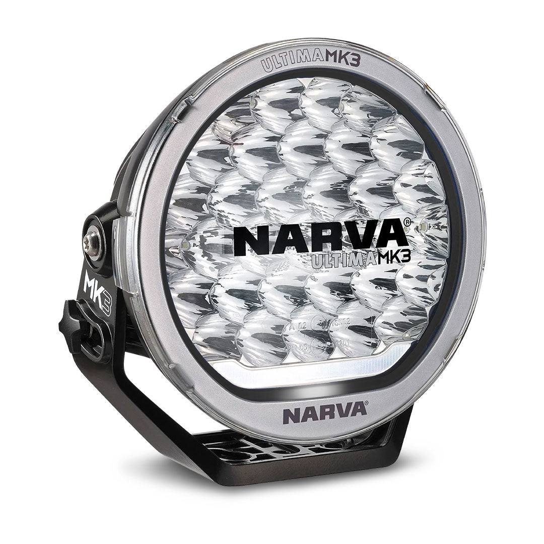Narva Ultima MK3 215 LED driving light with clear lens, black trim ring, and sturdy mounting bracket designed for premium off-road performance.