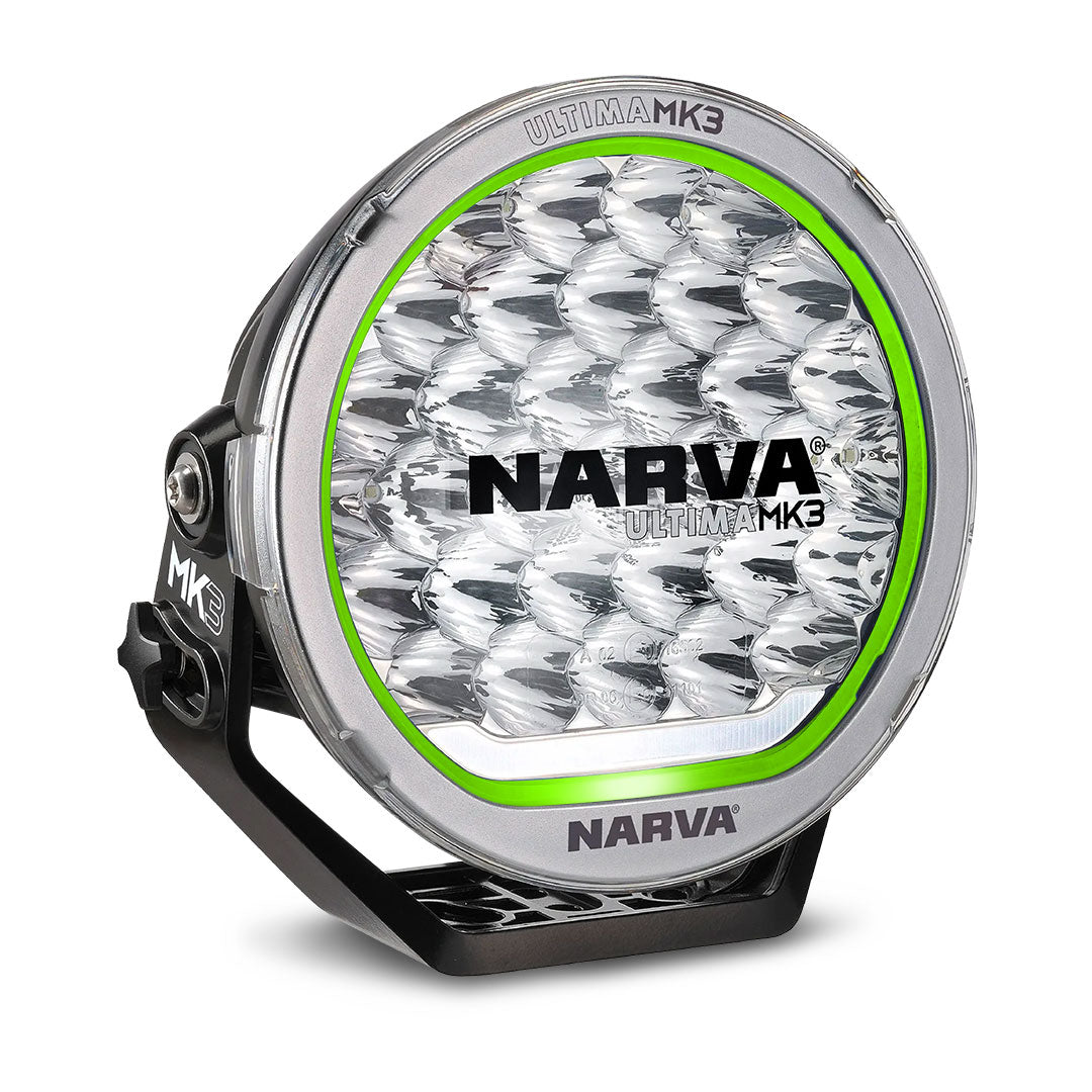 Narva Ultima MK3 215 LED driving light with clear lens, green trim ring, and durable black mounting bracket for high-performance off-road lighting.