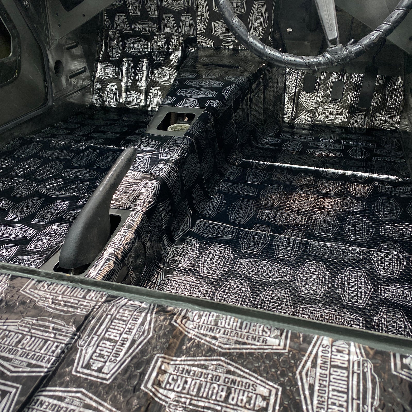 Large car floor pan covered with Stage 1 Sound Deadener