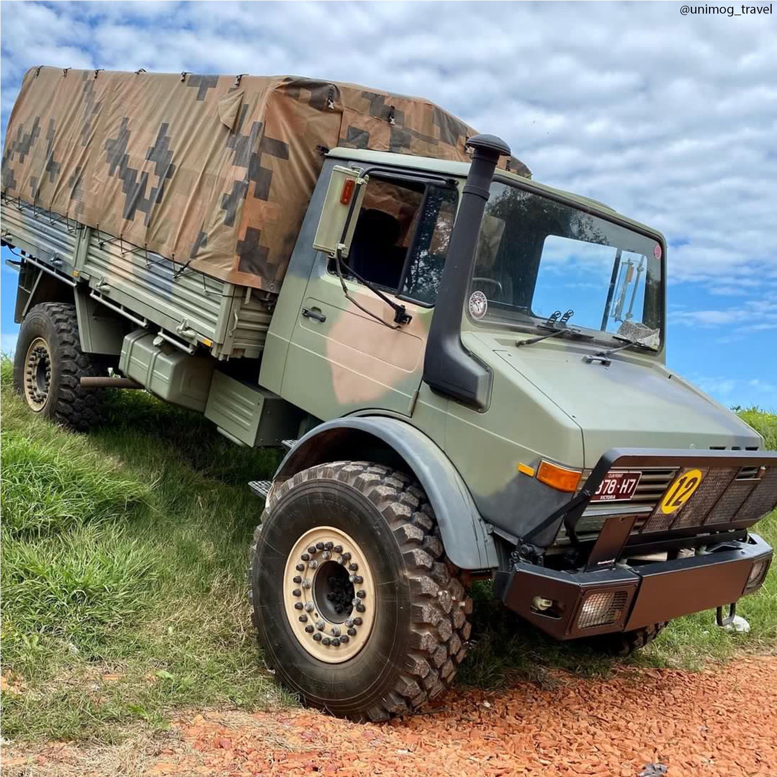 Camouflaged off road light truck with a canvas canopy