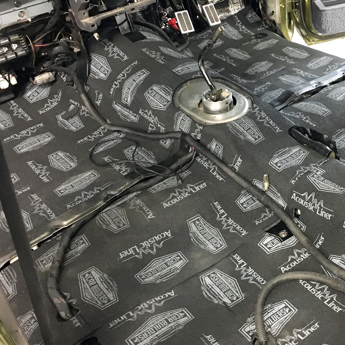 Deadened car floor with Acoustic Liner partly laid over the top
