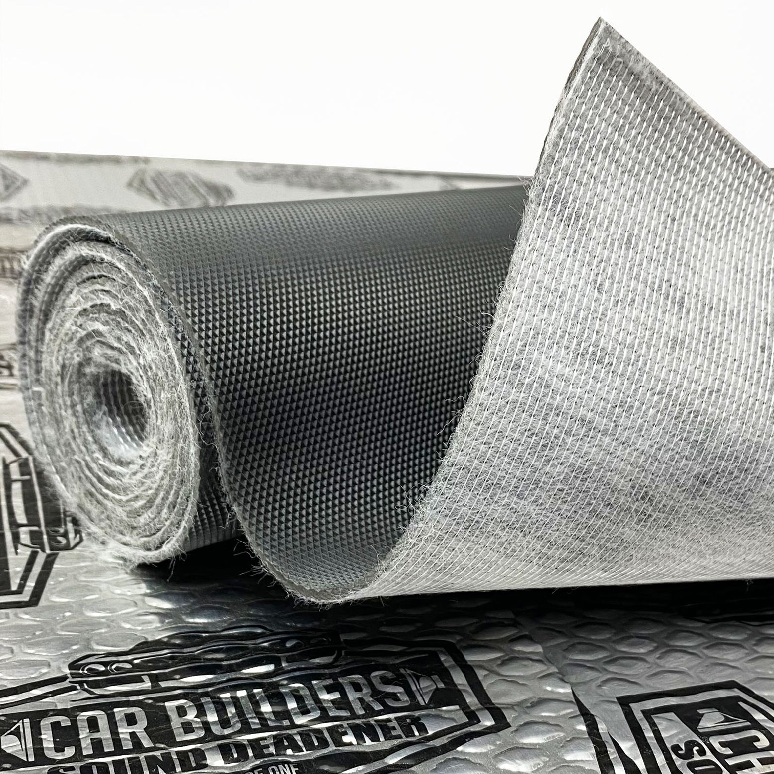Roll of Car Builders Mass Loaded Vinyl showing the grained face and textile back