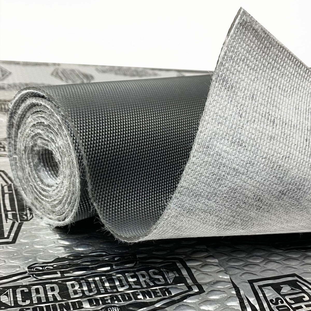 Roll of Car Builders Mass Loaded Vinyl showing the grained face and textile back