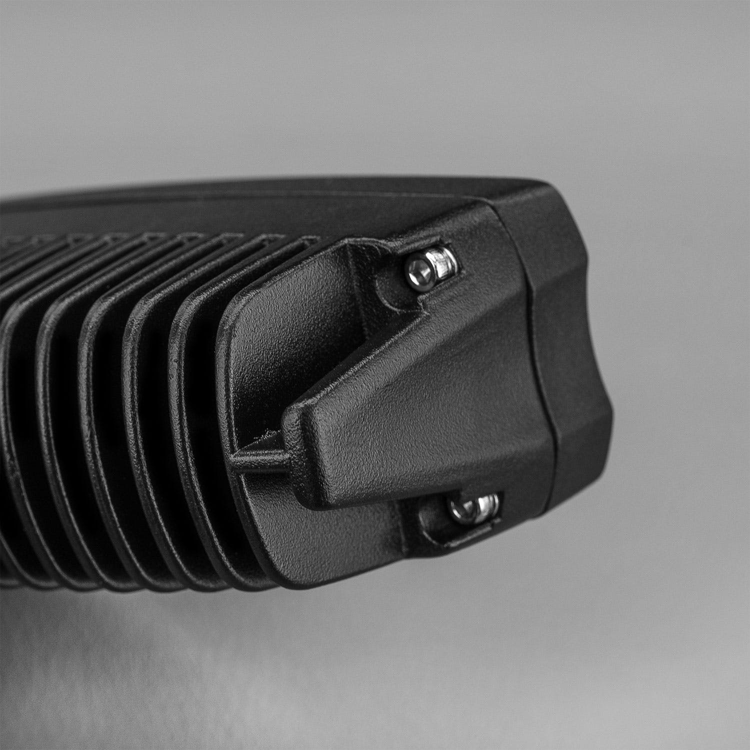 End of the finned housing showing the side bracket and its two screws