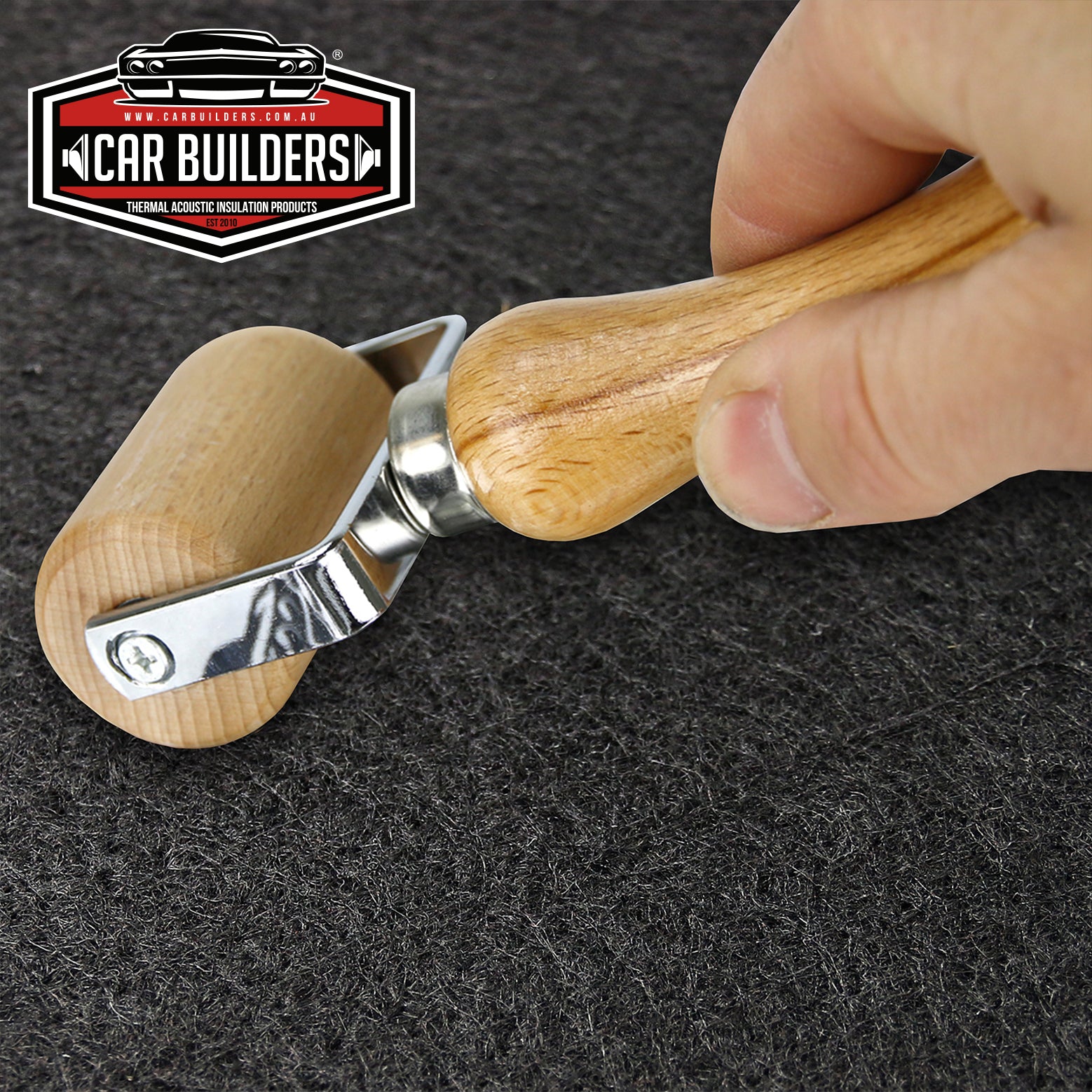 Rolling Car Builders bonnet insulation down with an application roller