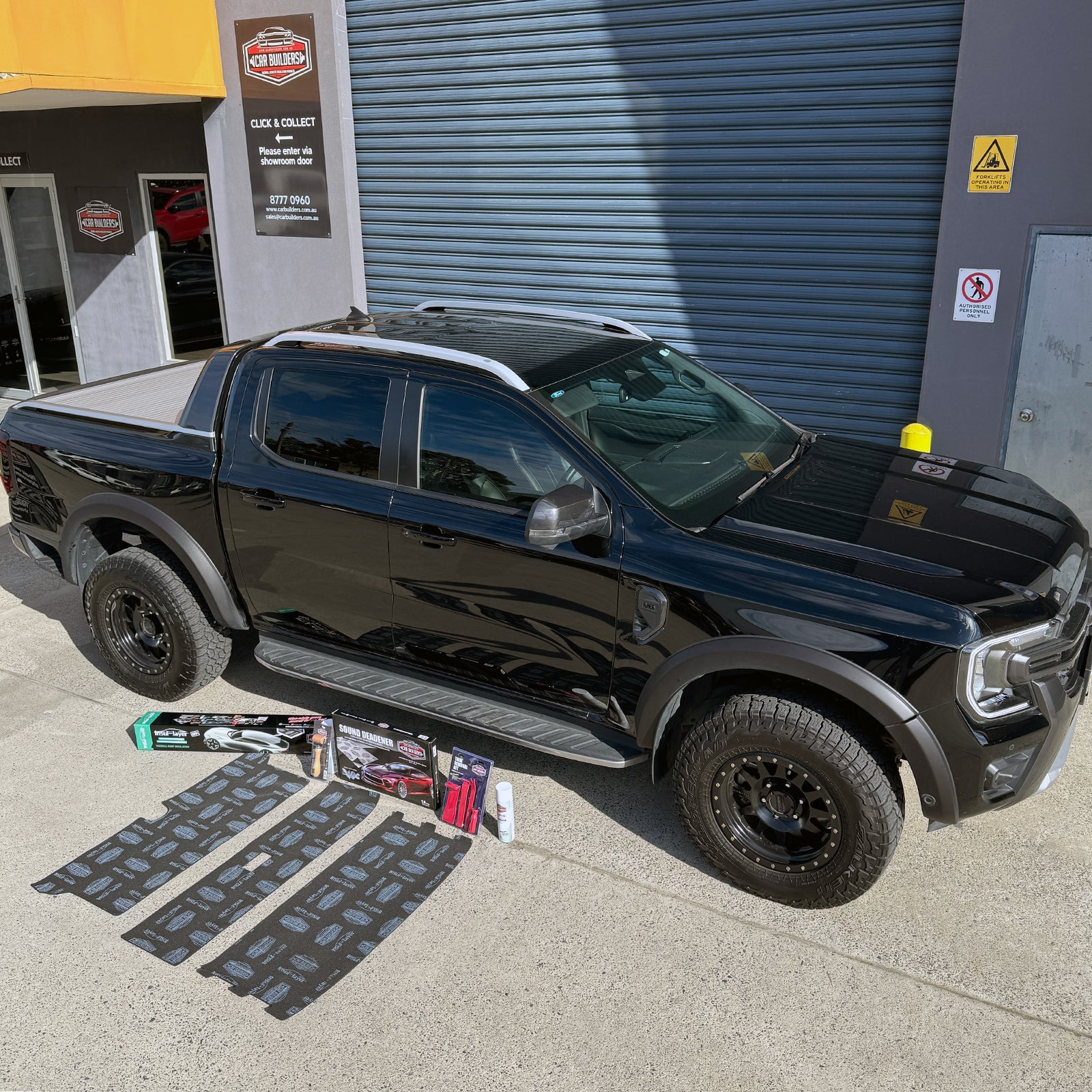 Black Next Gen Ford Ranger beside the laid out roof pack