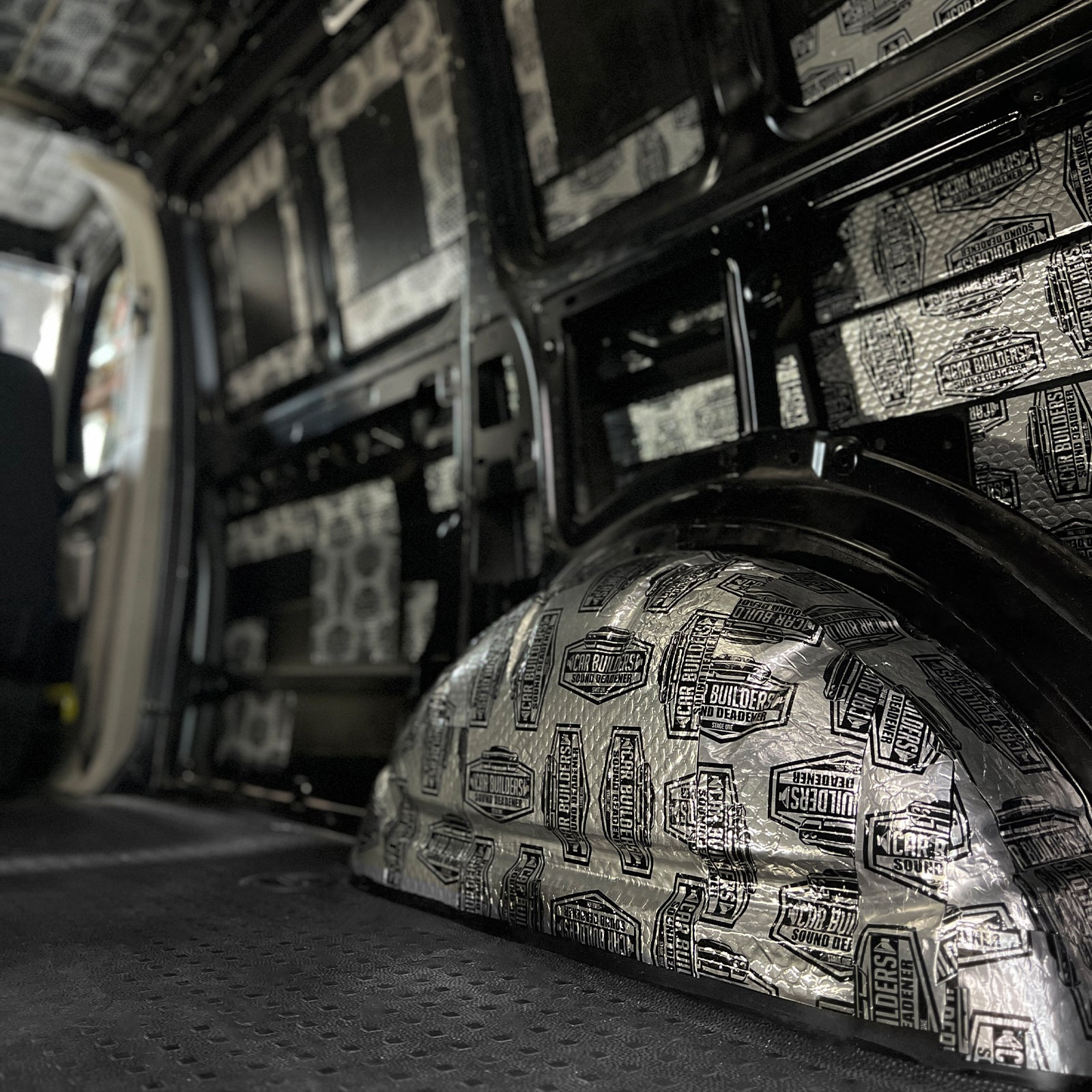 Van wheel arch and wall covered in silver sound deadener