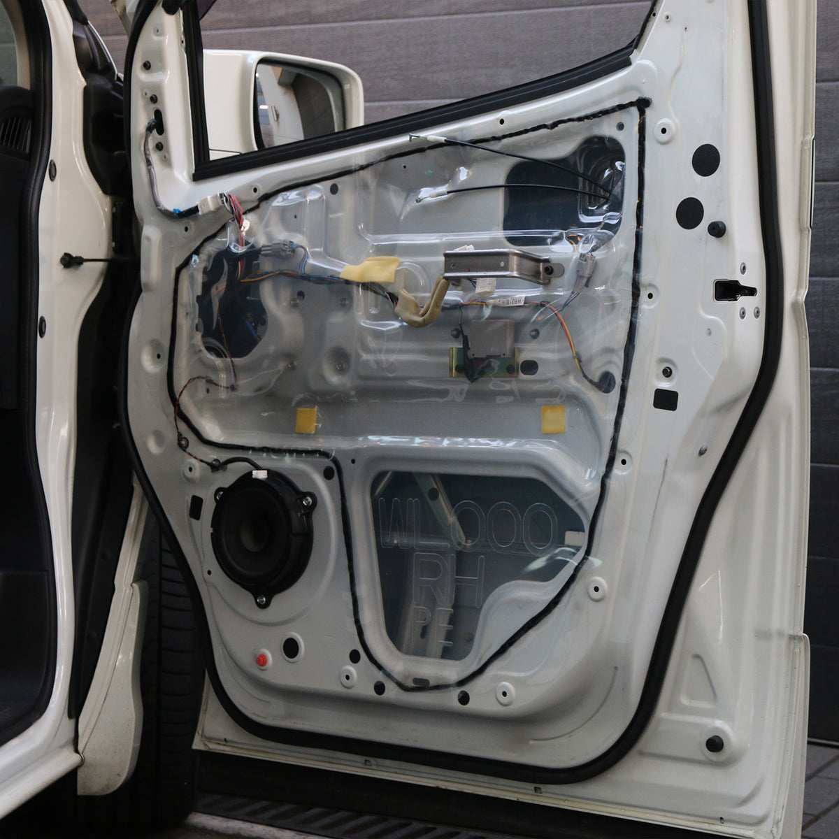 Door card membrane refitted to an open car door with Seal It