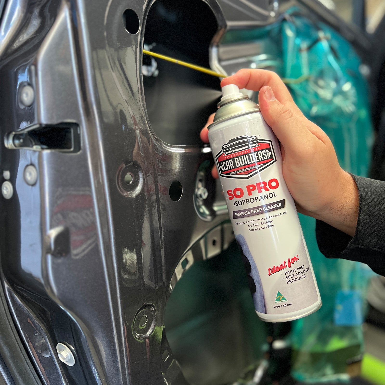 Spraying cleaner into an open door cavity before deadener