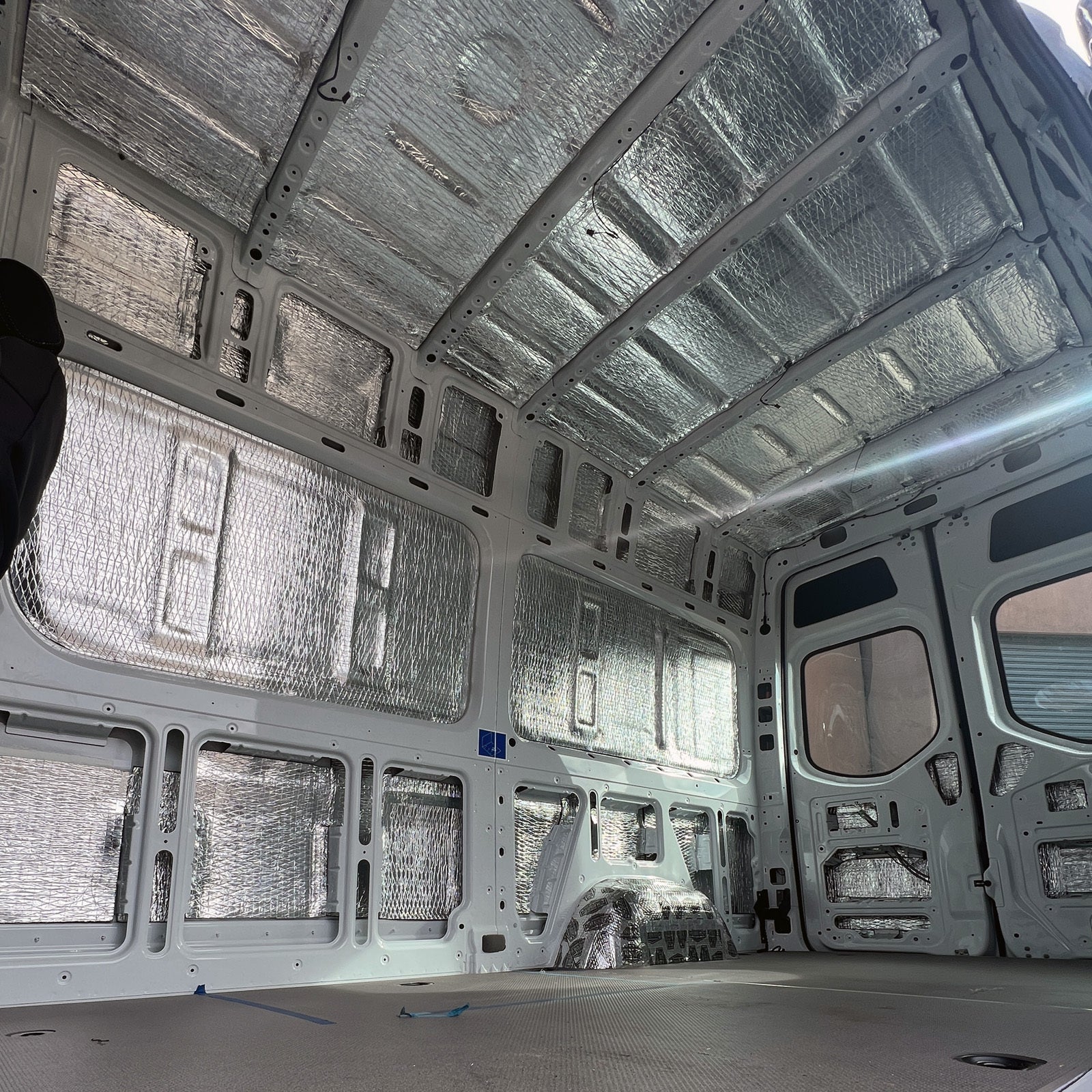 Sprinter cargo area with Van Liner on walls and roof, looking to the rear doors