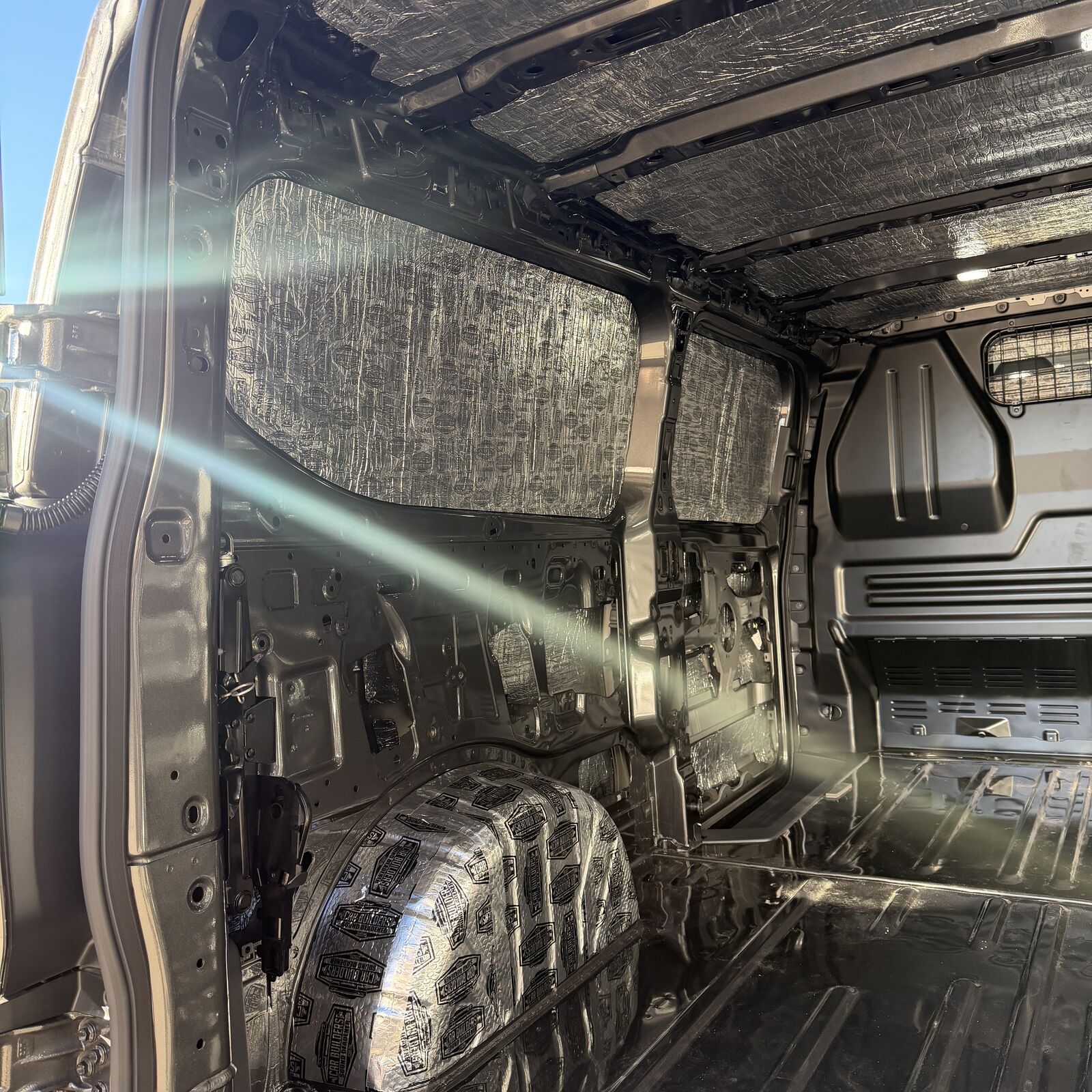 Transit Custom cargo area with Stage 1 deadener on the walls and roof