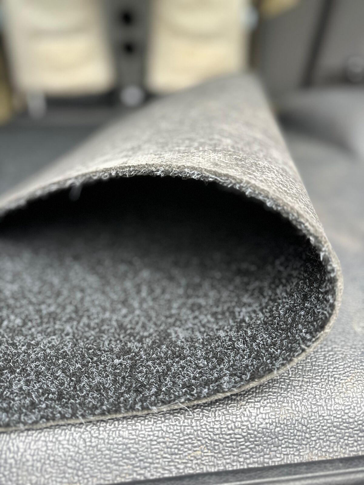 Edge of the Troopy marine carpet mat rolled back