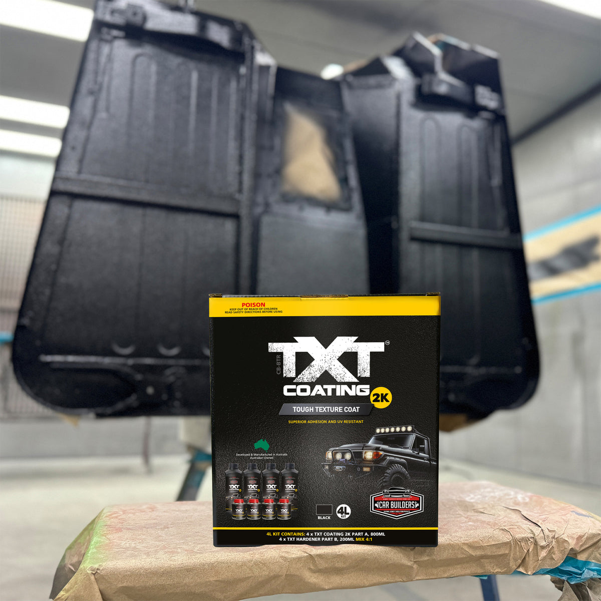 Car seats coated in black TXT 2K beside the kit box in a spray booth