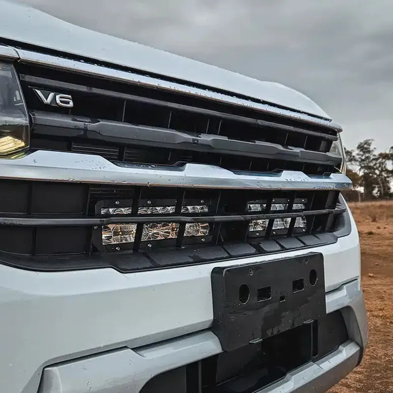 Ultra Vision behind-grille LED light bars for VW Amarok, featuring a long bar and two smaller units with clear-lens, black-body design. installed to the car 
