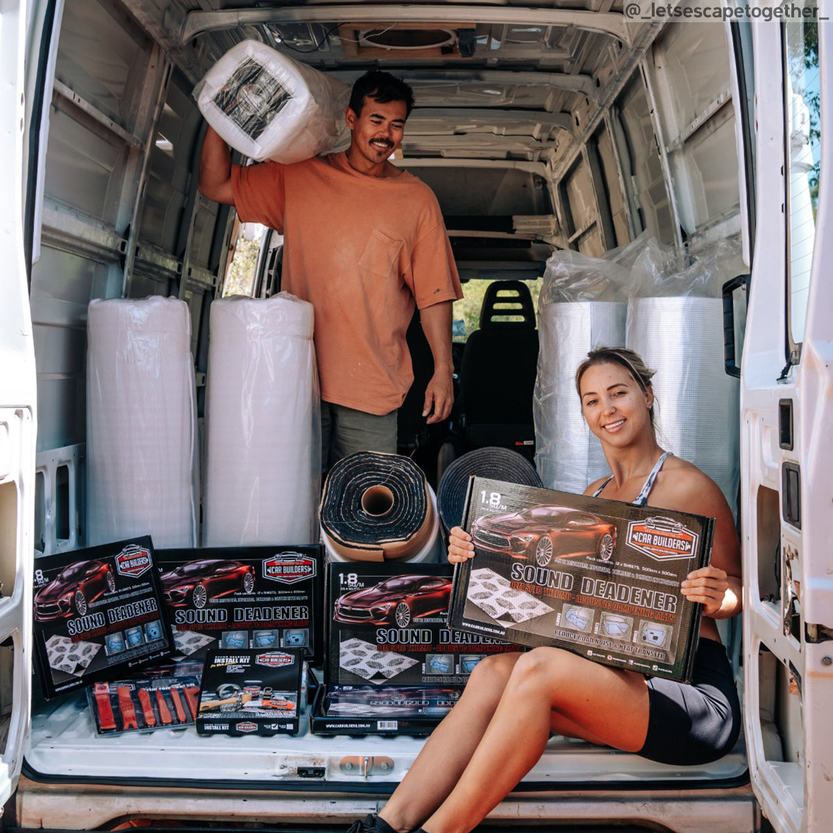 Two people in a van with rolls of Van Liner and boxes of deadener