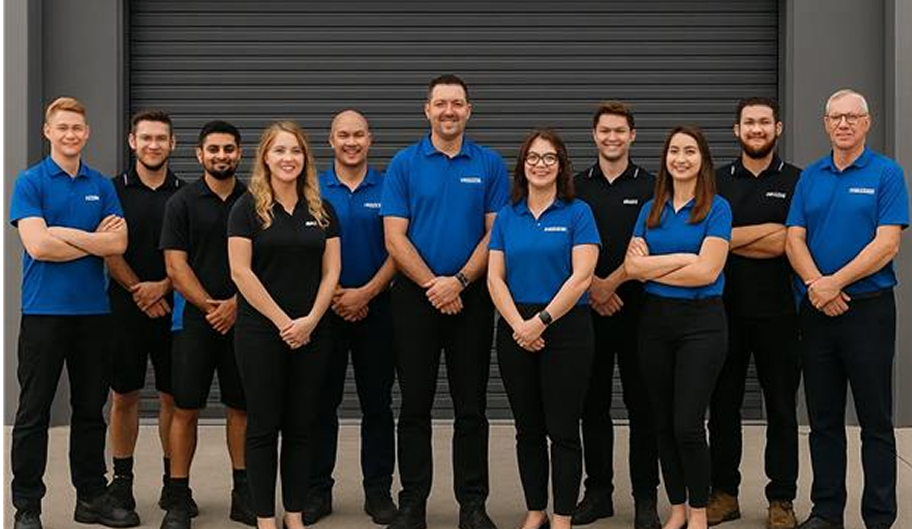 frankies auto electrics'  employee standing in front of a dark background
